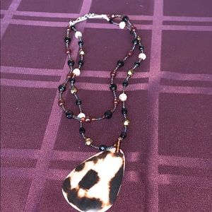 Brown necklace with shell like pendant
